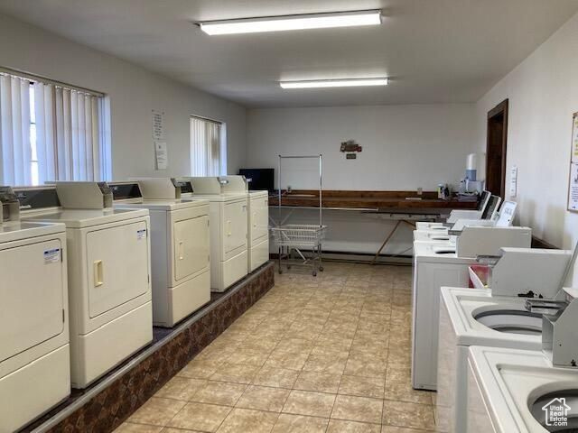 Laundry area with separate washer and dryer and light tile floors