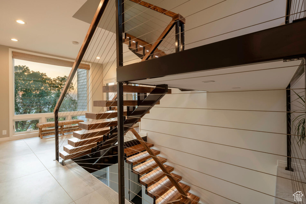 Stairs featuring light tile floors
