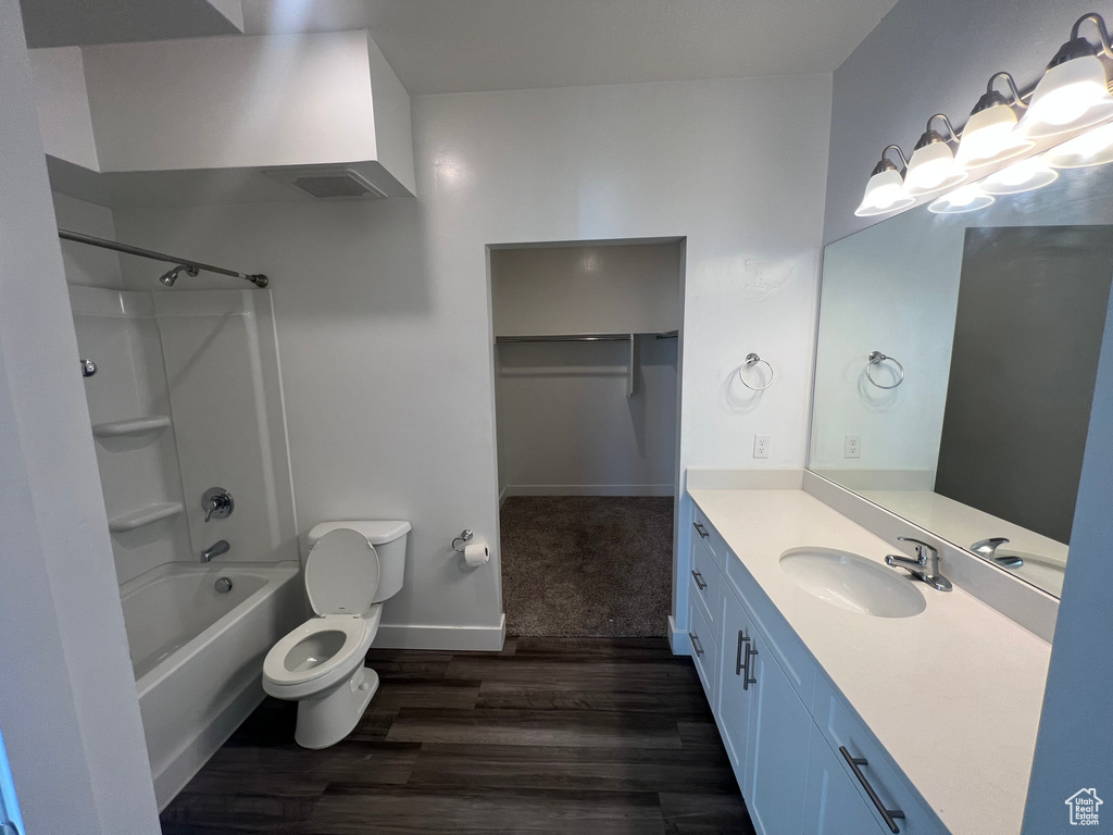 Full bathroom featuring tub / shower combination, hardwood / wood-style floors, toilet, and vanity