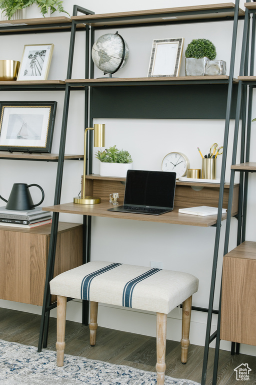 Office space with dark hardwood / wood-style floors