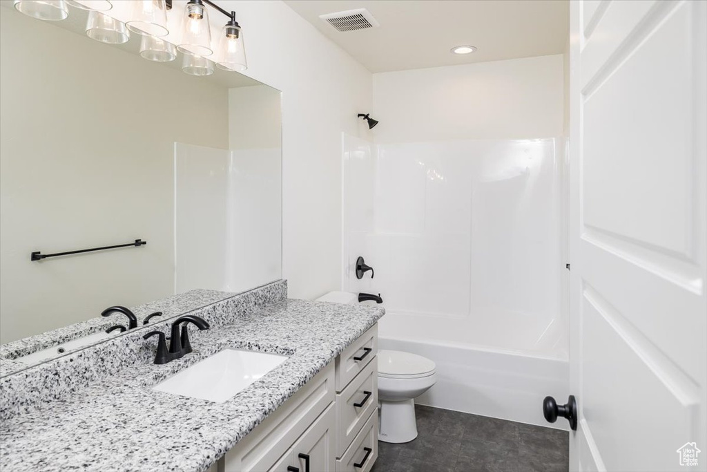 Full bathroom featuring large vanity, shower / bathing tub combination, toilet, and tile flooring