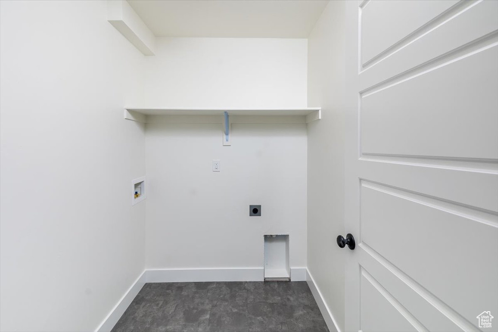 Washroom with hookup for a washing machine, dark tile flooring, and hookup for an electric dryer