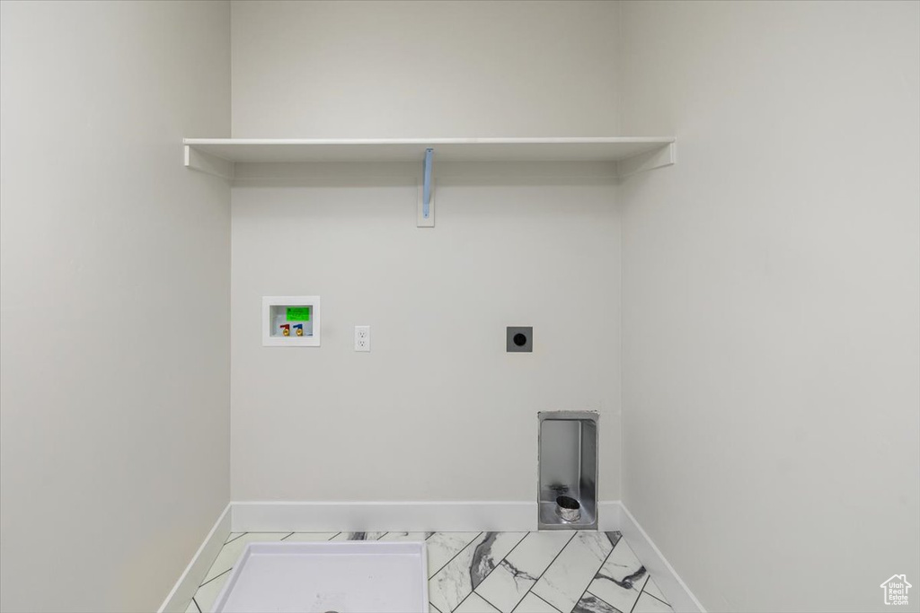 Washroom with washer hookup, light tile floors, and hookup for an electric dryer