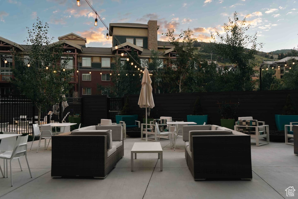 Patio terrace at dusk with outdoor lounge area