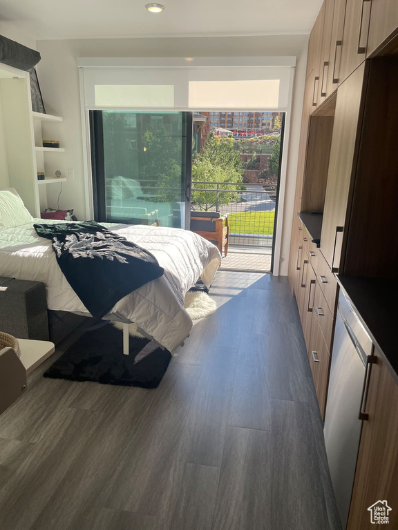 Bedroom featuring access to exterior and dark hardwood / wood-style flooring