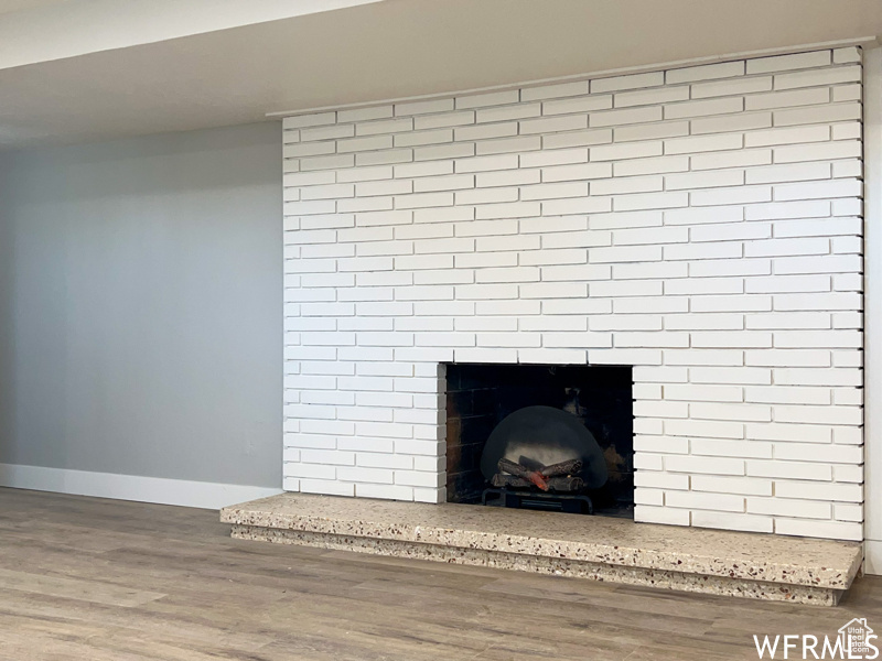 Room details with dark wood-type flooring and a fireplace