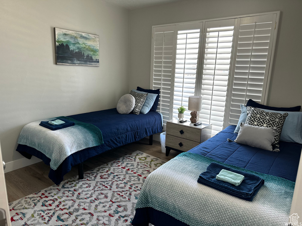 Bedroom with hardwood / wood-style flooring