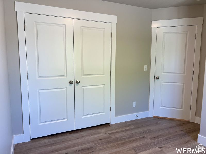 Unfurnished bedroom with a closet and light wood-type flooring