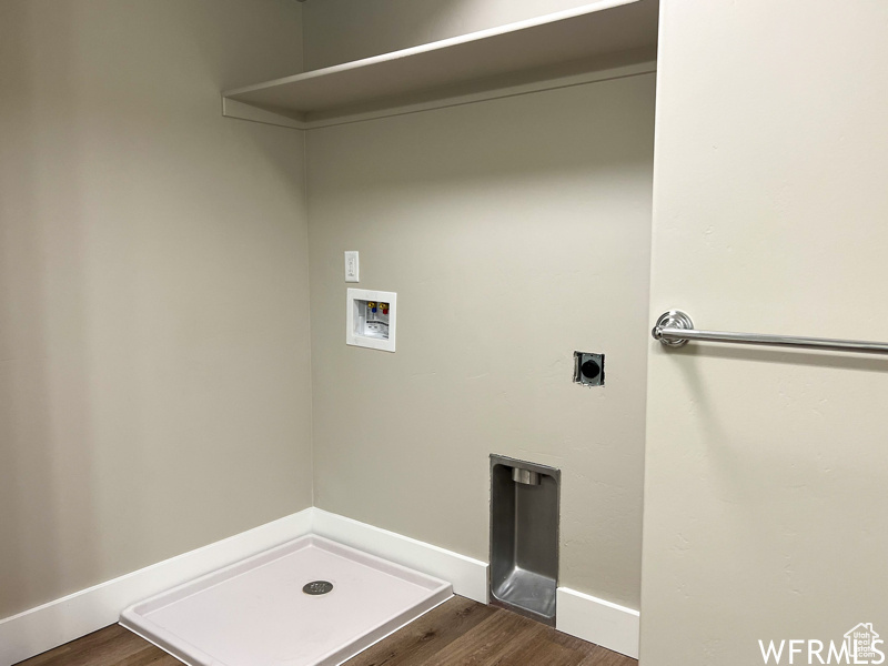 Laundry area featuring dark wood-type flooring, electric dryer hookup, and hookup for a washing machine