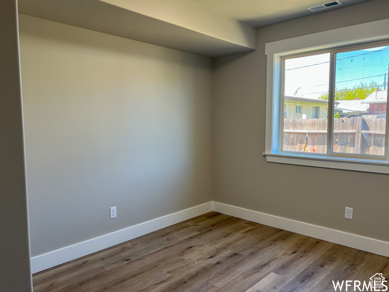 Empty room with light hardwood / wood-style floors