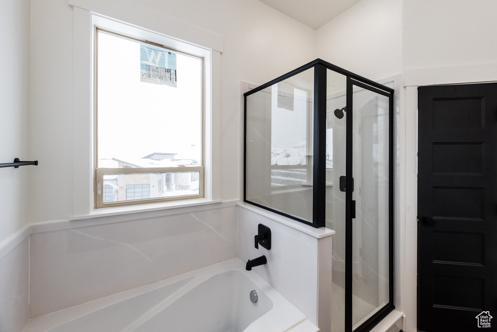 Bathroom featuring a wealth of natural light and plus walk in shower