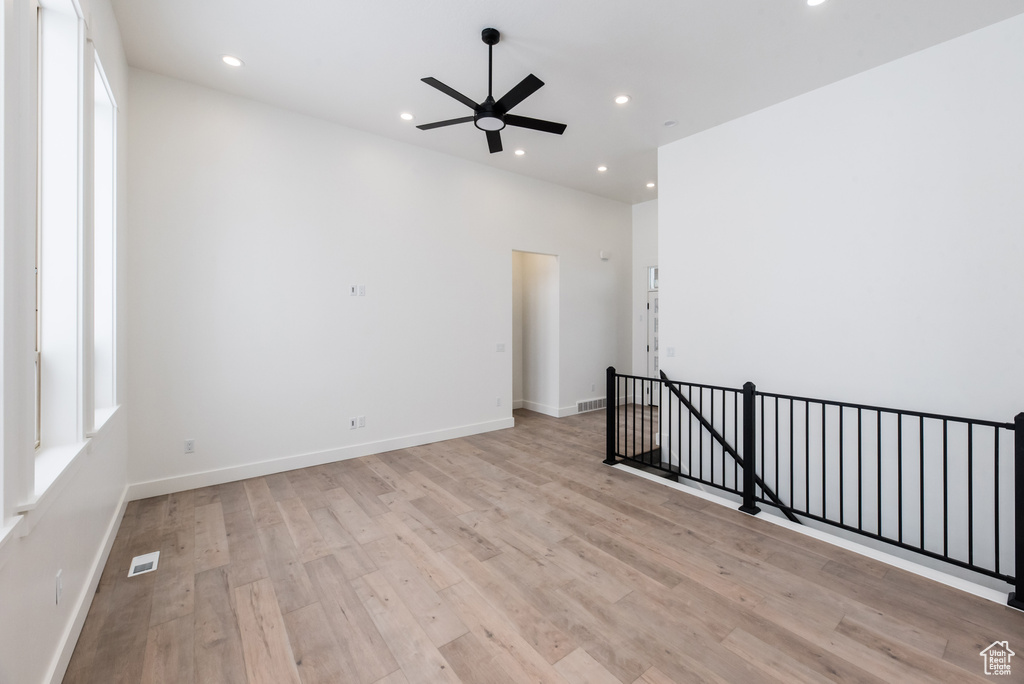 Unfurnished room featuring light wood-type flooring and ceiling fan