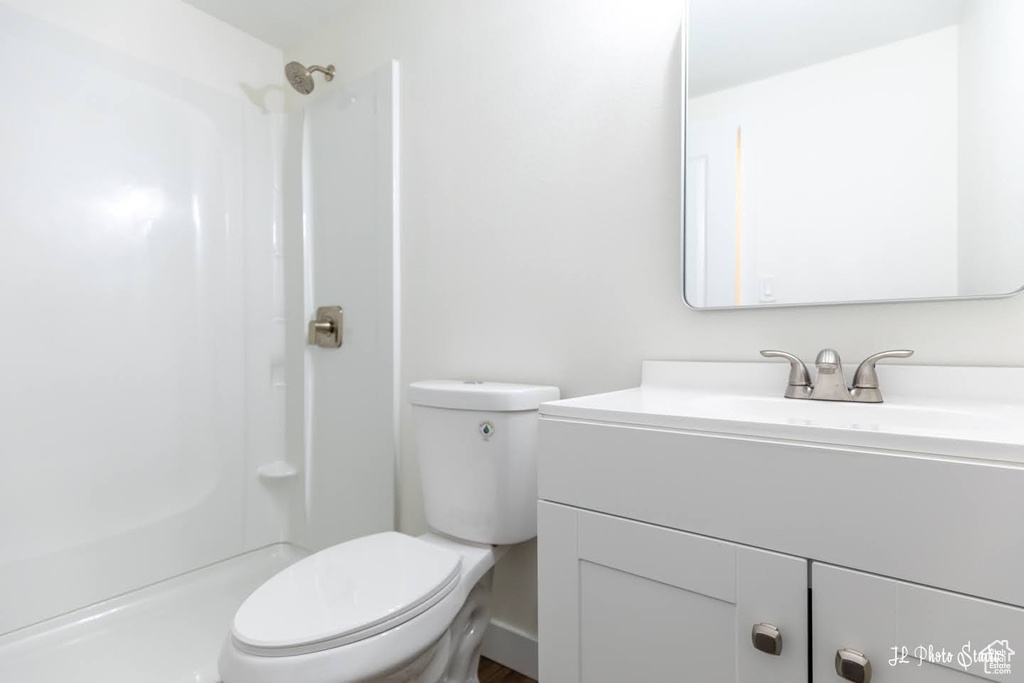 Bathroom with a shower, toilet, and large vanity