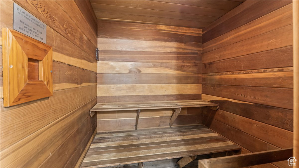 View of sauna / steam room with wood walls and wooden ceiling