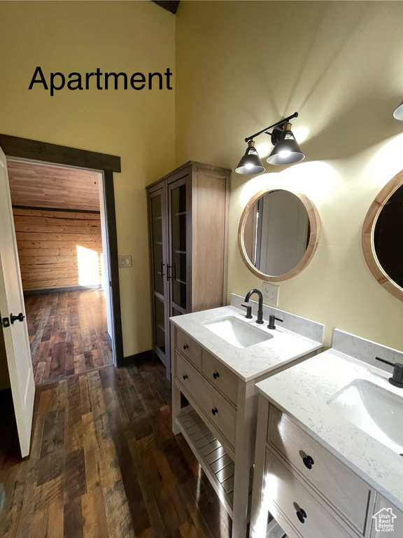 Bathroom featuring dual vanity and hardwood / wood-style flooring