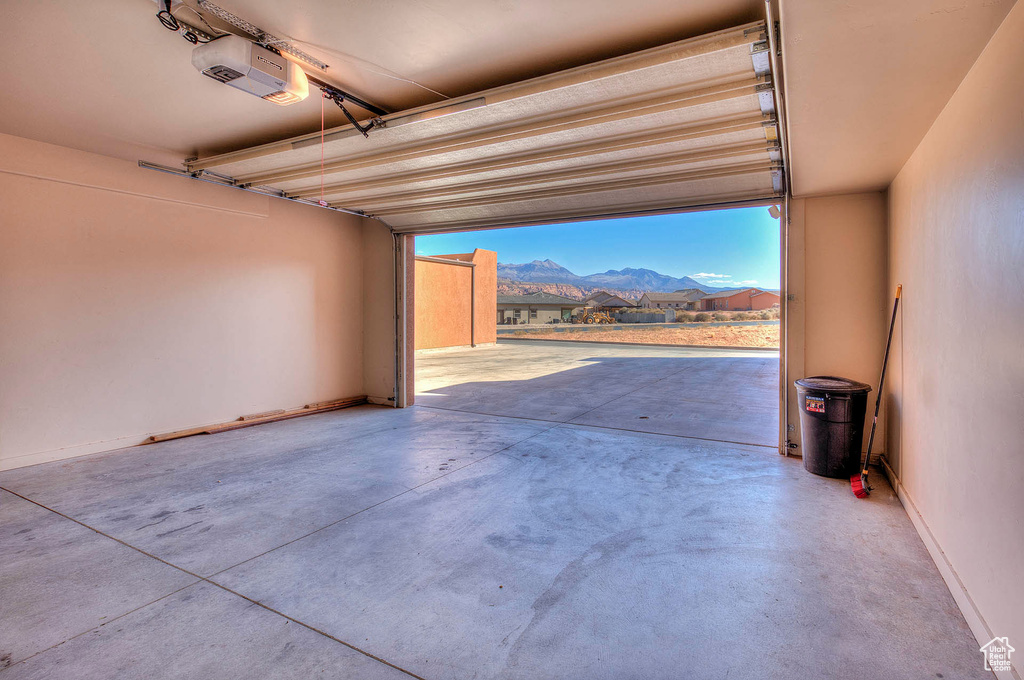 Garage with a garage door opener and a mountain view