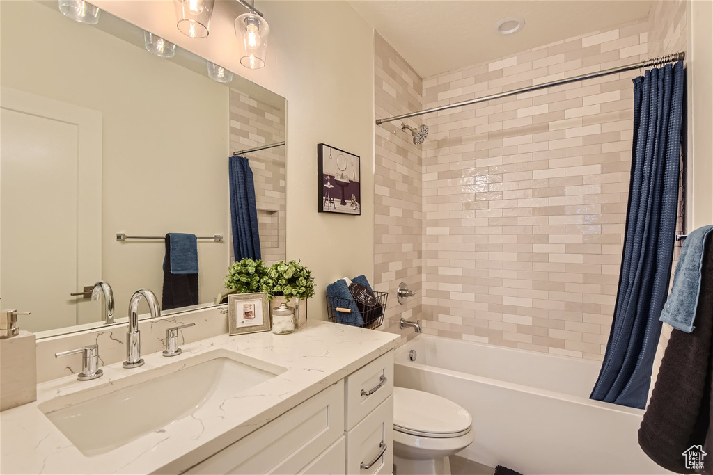 Full bathroom with vanity, toilet, and shower / tub combo