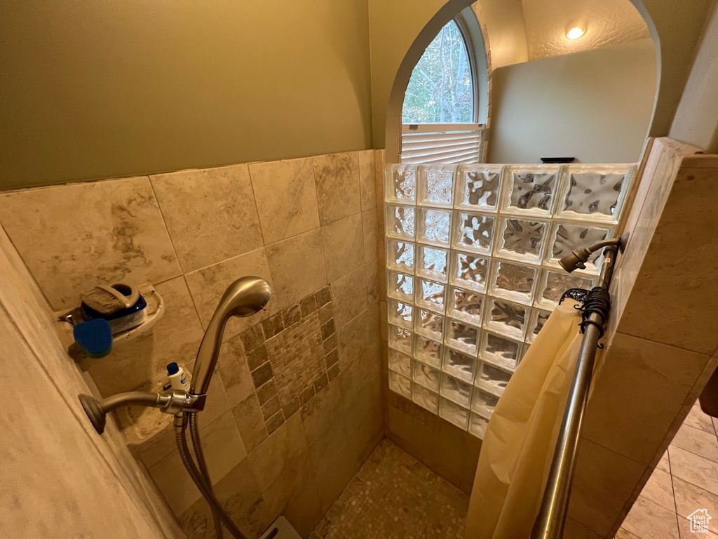 Bathroom with tile floors and tiled shower