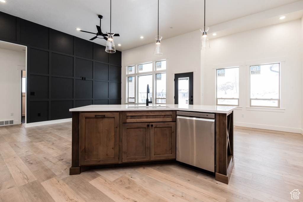 Kitchen featuring pendant lighting, light hardwood / wood-style flooring, dishwasher, and ceiling fan