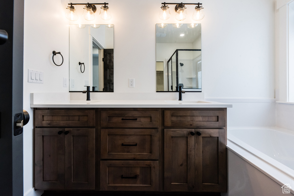 Bathroom featuring double sink vanity and a bathing tub