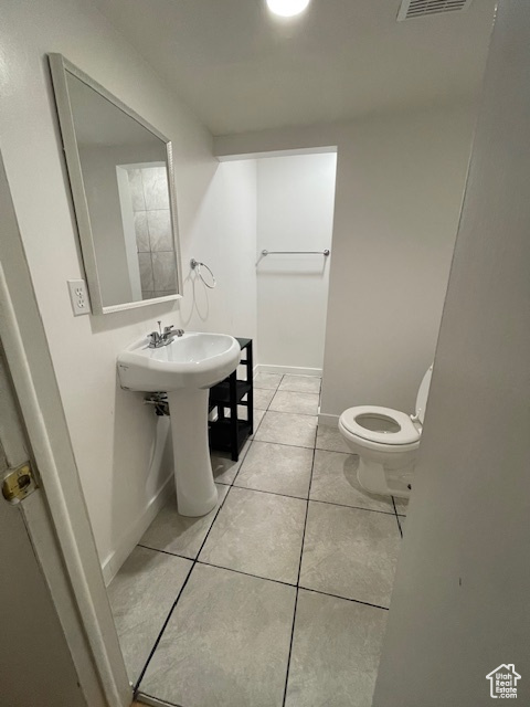 Bathroom with tile floors, sink, and toilet