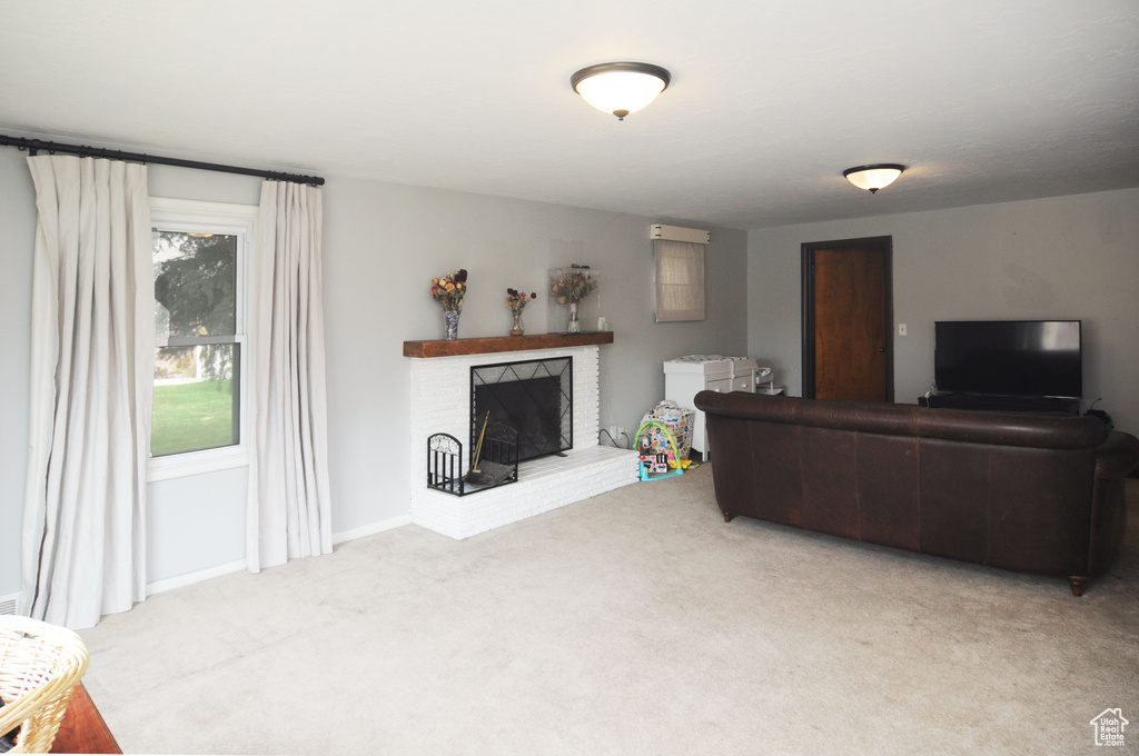 Living room with a brick fireplace and carpet