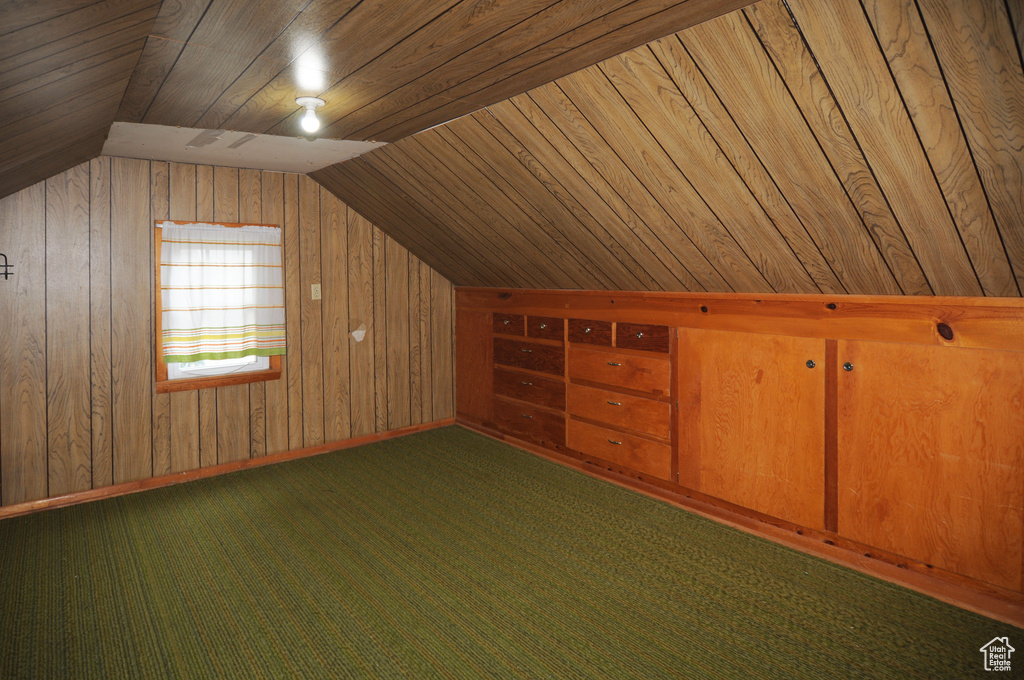 Bonus room with wood ceiling, wooden walls, and lofted ceiling