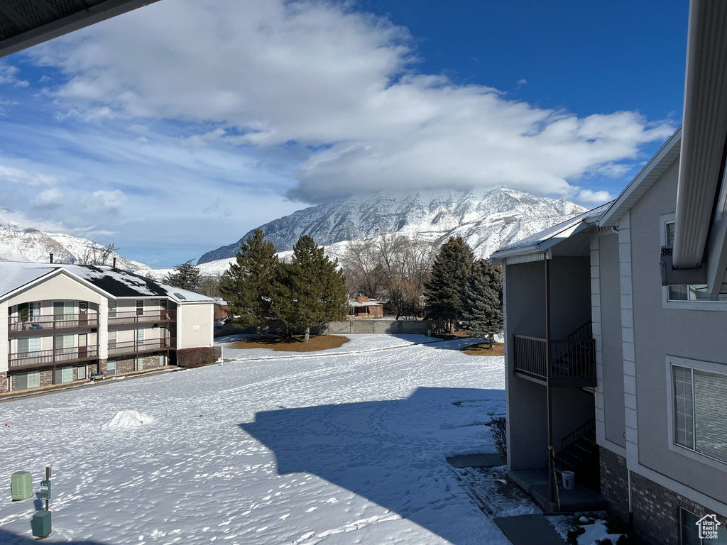 Snowy yard featuring a mountain view