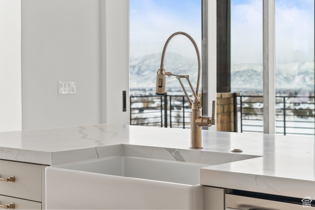 Room details with a mountain view, sink, and a bathtub