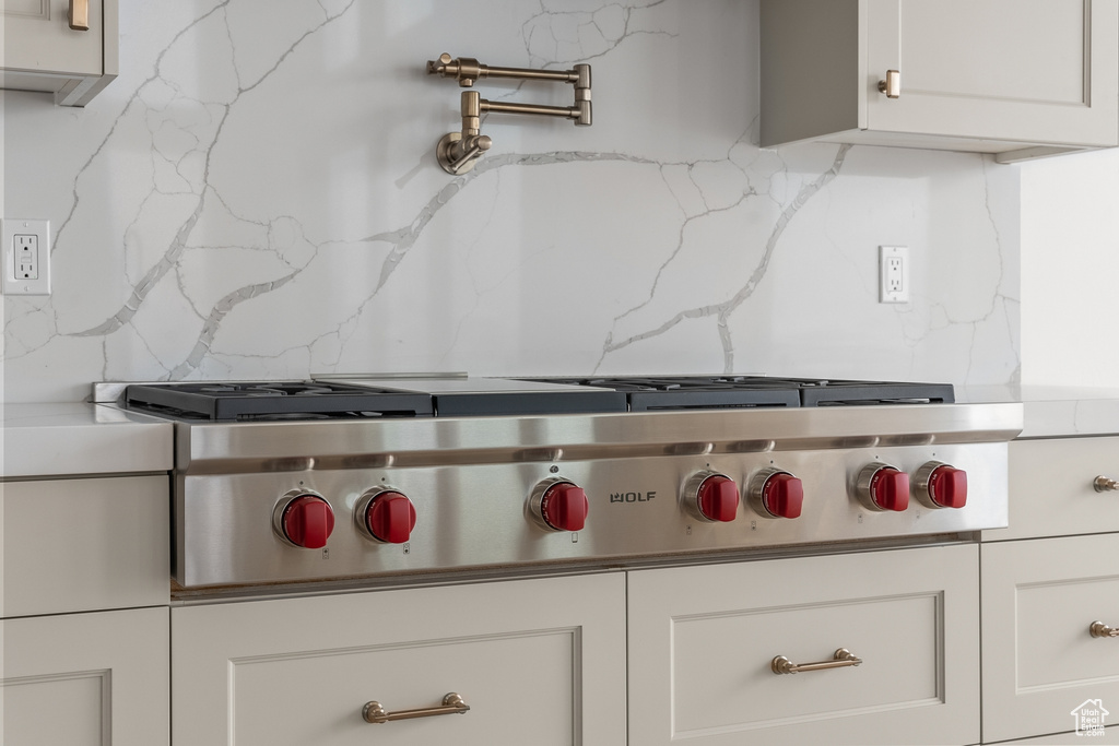 Details with stainless steel gas stovetop and backsplash