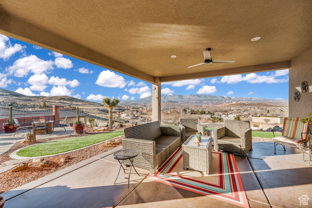 View of terrace featuring an outdoor living space, a mountain view, and ceiling fan