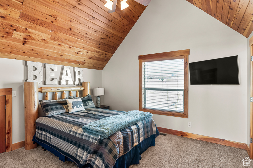 Bedroom featuring wooden ceiling, lofted ceiling, ceiling fan, and carpet