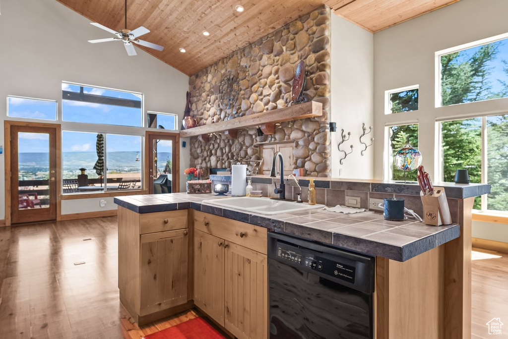 Kitchen featuring ceiling fan, wood ceiling, black dishwasher, high vaulted ceiling, and sink