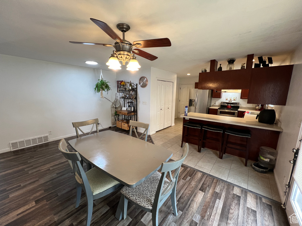 Tiled dining room with ceiling fan