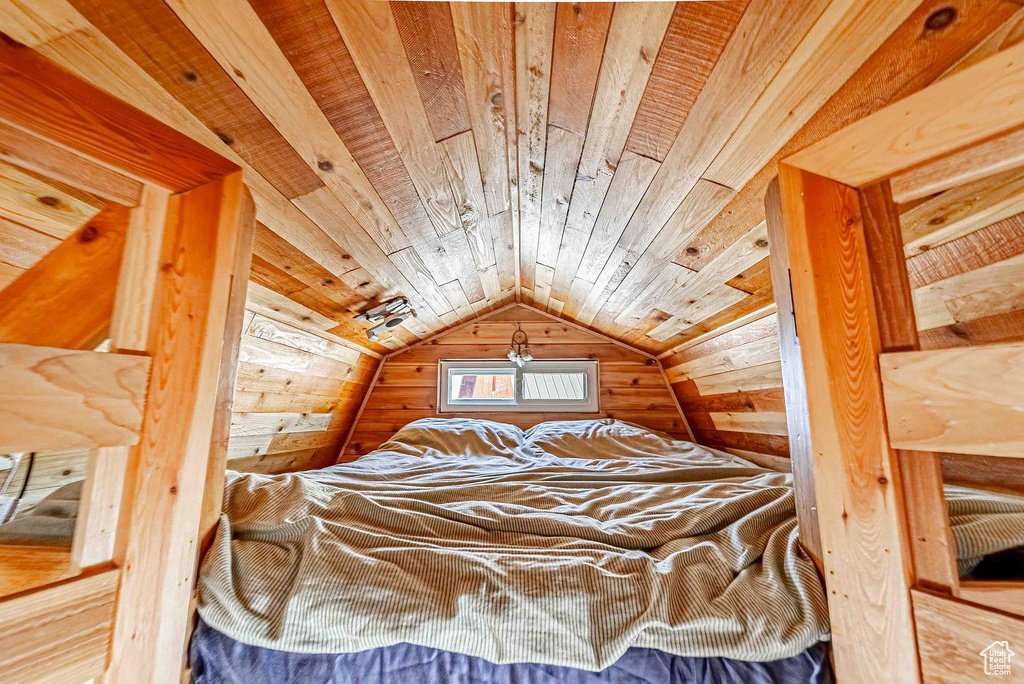 Bedroom with wooden ceiling and vaulted ceiling