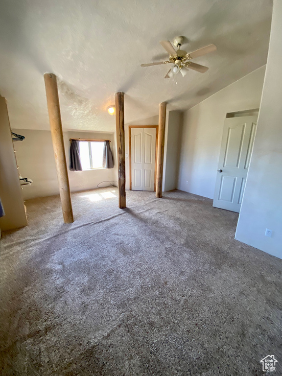 Interior space with carpet floors, lofted ceiling, and ceiling fan