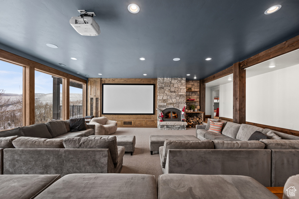 Home theater room with carpet flooring and a fireplace