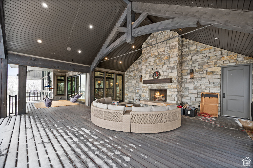 Deck with an outdoor living space with a fireplace