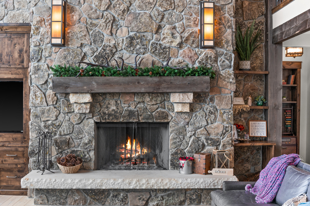 Exterior details featuring a stone fireplace and hardwood / wood-style floors