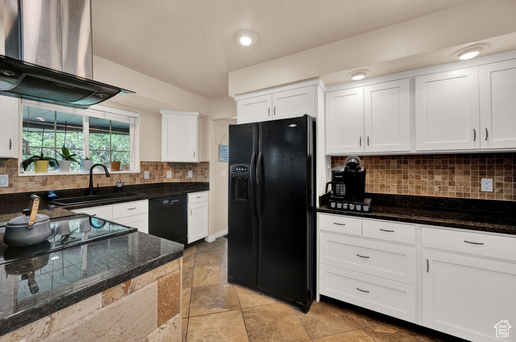 Kitchen featuring black appliances, backsplash, white cabinets, sink, and fume extractor