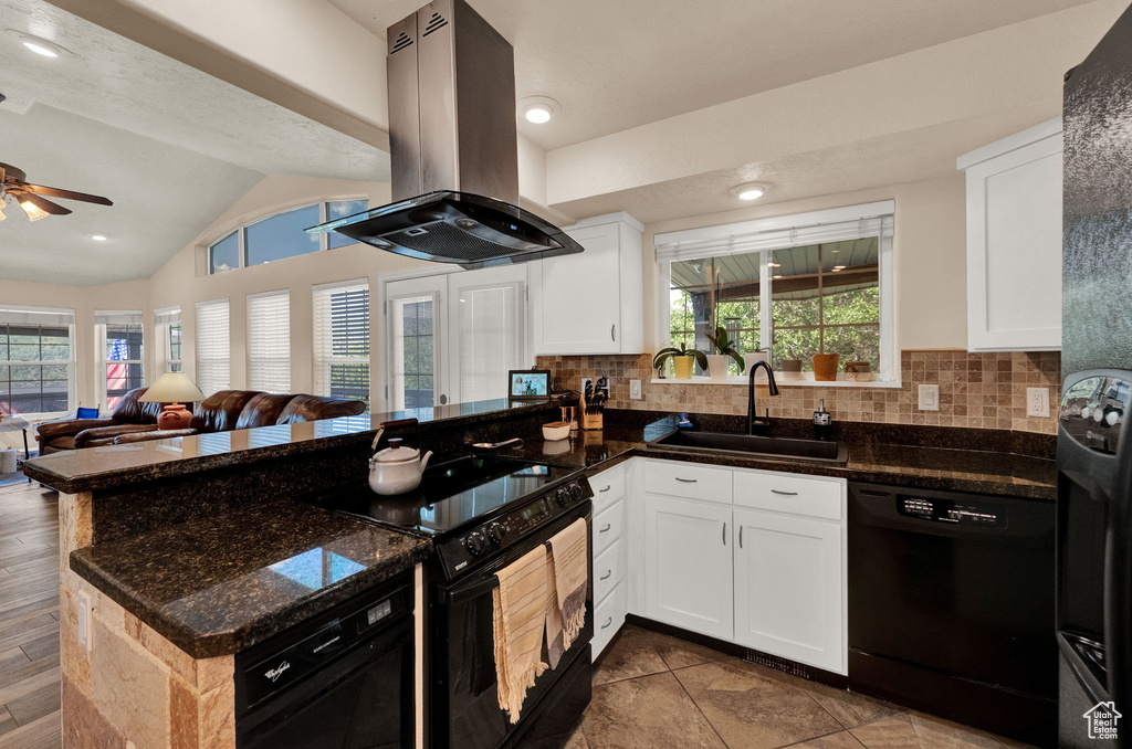 Kitchen featuring black appliances, ceiling fan, lofted ceiling, sink, and island exhaust hood