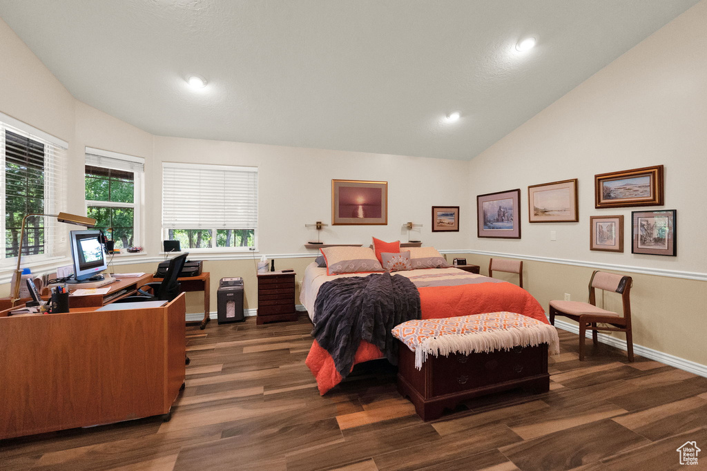 Bedroom featuring dark hardwood / wood-style flooring and lofted ceiling