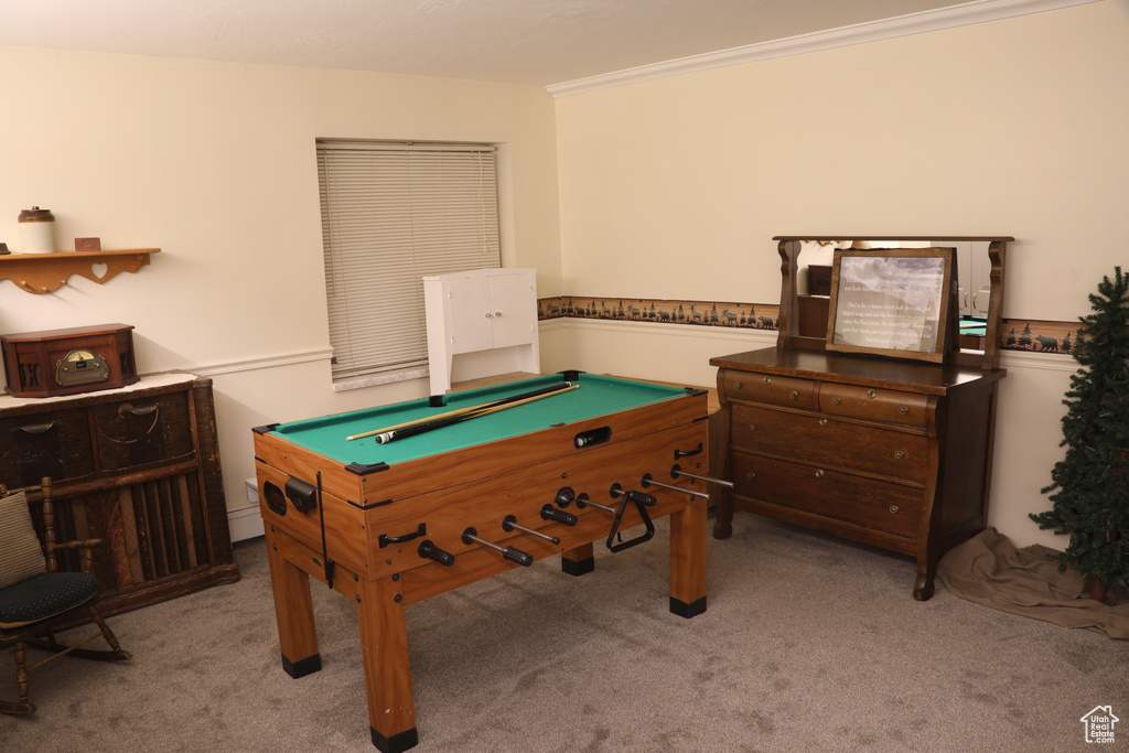 Game room with crown molding, light carpet, and billiards