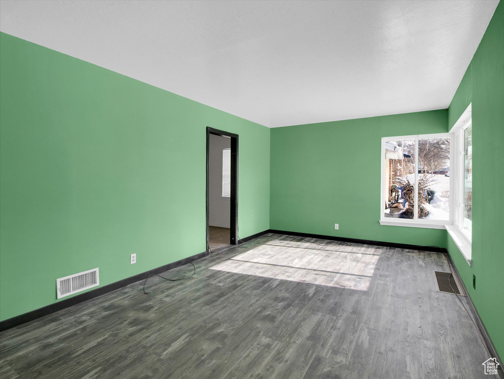Unfurnished room with dark hardwood / wood-style flooring