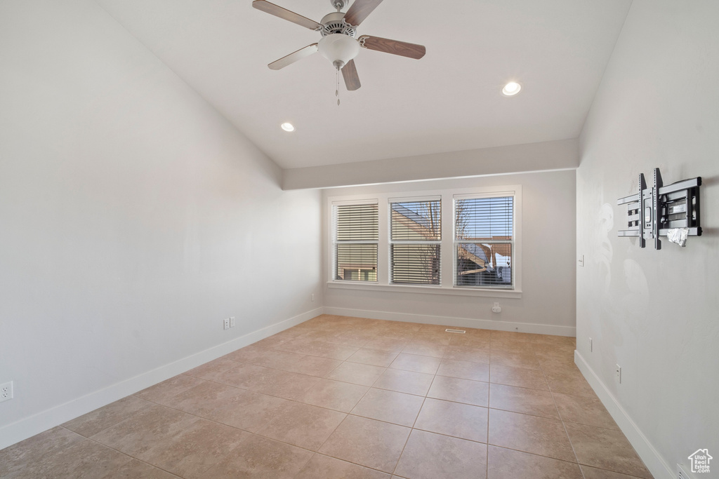Spare room featuring light tile flooring and ceiling fan