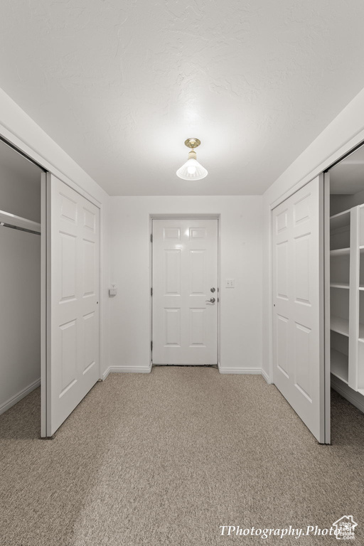 Unfurnished bedroom with light colored carpet