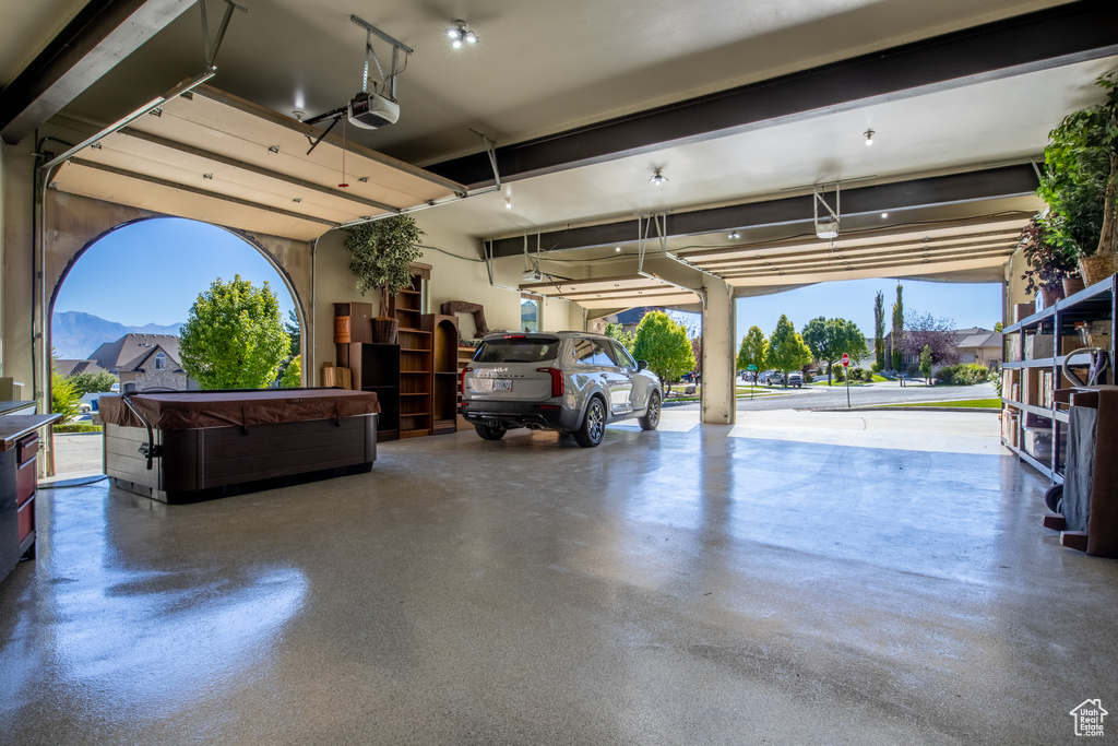 Garage featuring a mountain view and a garage door opener