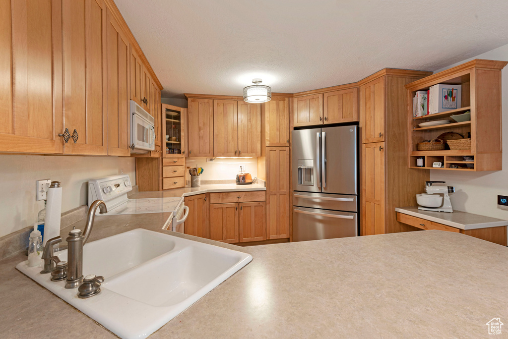 Kitchen with sink and white appliances