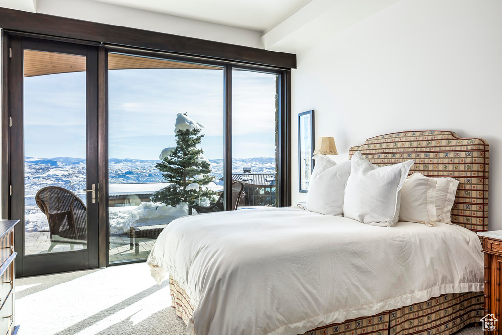 Carpeted bedroom featuring french doors, a mountain view, and access to exterior
