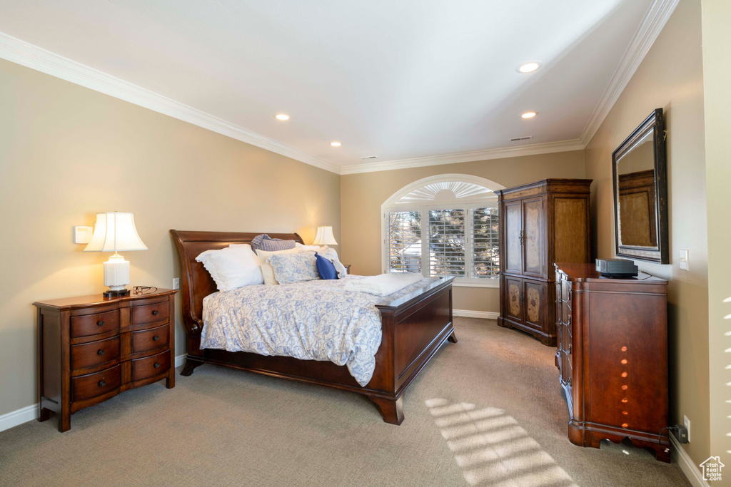Bedroom featuring ornamental molding and light carpet